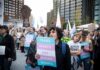 Transgender Killings Fall Nearly 50% Under Trump Crowd of protesters holding trans rights signs at a city rally