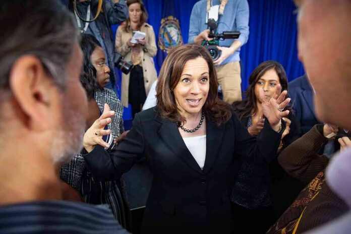 Kamala Harris speaks to a crowd as Maya Harris stands nearby