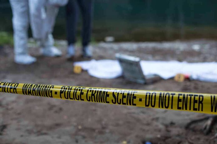 Police crime scene with yellow tape and forensic team