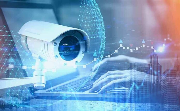 shutterstock_1477456025 Security camera overlaid on hands typing at a laptop
