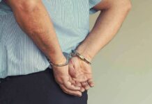 person in handcuffs with hands behind back
