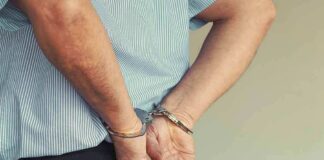 person in handcuffs with hands behind back