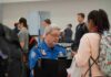 Bill Bergey, a TSA officer, checks a traveler's documents at an airport security checkpoint