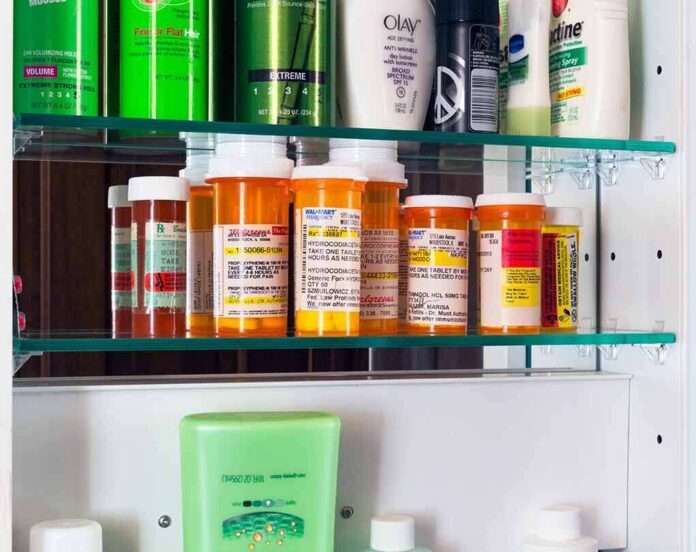 shutterstock_1643578801 Medicine cabinet with prescription bottles and toiletries