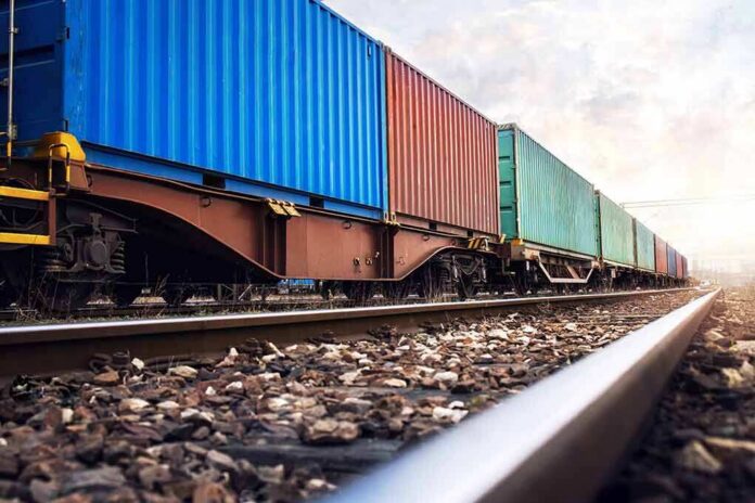 Freight train with colorful shipping containers on railway tracks
