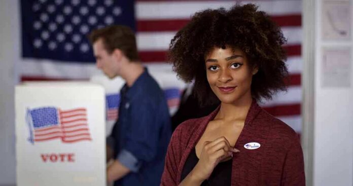 Voter showing an I Voted sticker at a polling place