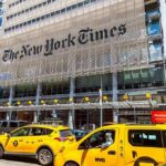 New York Times building with yellow taxis in front