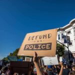 protesters holding signs at a street demonstration