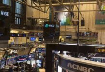 NYSE trading floor with monitors and tickers