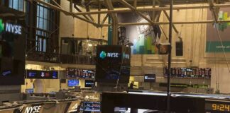 NYSE trading floor with monitors and tickers