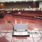 Top Democrat Machine Under Criminal Cloud Conference microphone on a podium in a courtroom
