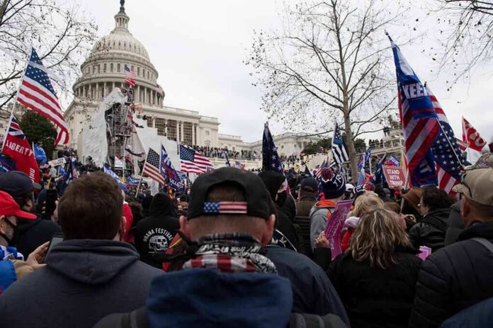 crowd with flags gathered outside the U.S. Capitol building