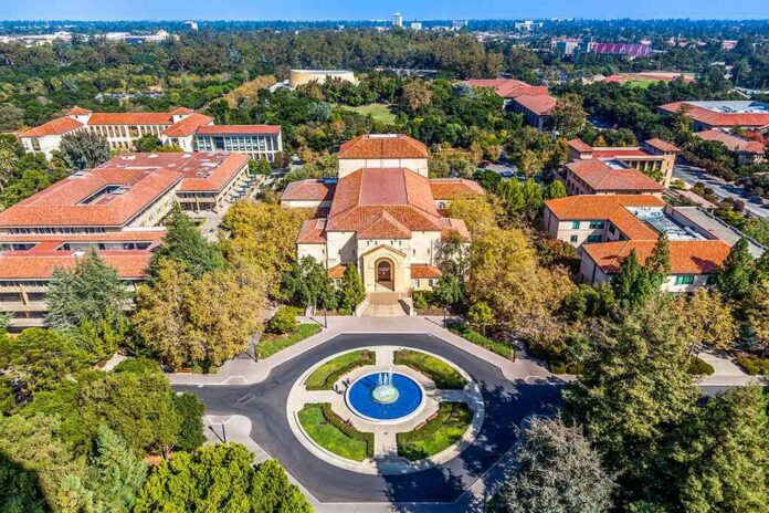 Aerial view of a campus building with red-tile roofs and a round fountain plaza