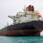 Hormuz Erupts: Tankers Turned War Targets Large oil tanker anchored in calm sea