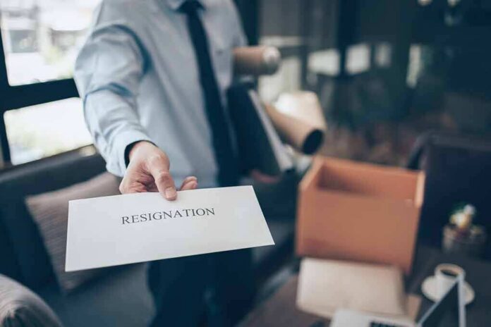 employee handing over a resignation letter