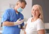 Vance Makes STUNNING Claim About America’s Wars Smiling woman receiving a vaccination from a healthcare worker