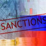 Sanctions text over financial chart and flag with coin stacks
