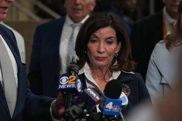 Woman speaking to reporters at a press scrum