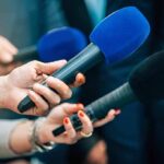 Trump-Backed Upset Brewing In California? Reporters holding colorful microphones