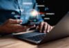 Person using smartphone and laptop with AI hologram