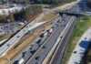 Aerial view of multi-lane highway interchange with overpass and traffic