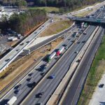 Aerial view of multi-lane highway interchange with overpass and traffic