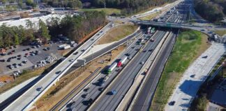 Aerial view of multi-lane highway interchange with overpass and traffic