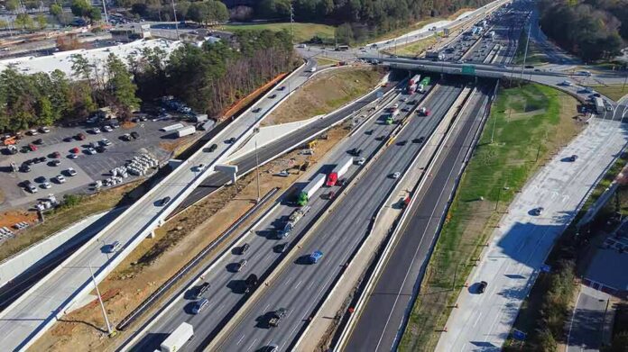 Aerial view of multi-lane highway interchange with overpass and traffic