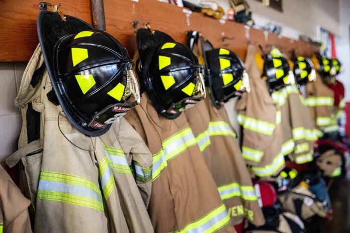 shutterstock_2302178425 Firefighter helmets and turnout coats hanging on hooks
