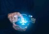 Hands using smartphone with glowing justice scale and AI icons