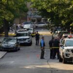 Manifesto Fury Behind Montreal Bloodshed Police officers secure a residential street with patrol cars and yellow tape