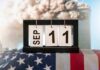 Perpetual desk calendar showing Sep 11 on an American flag