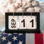 Perpetual desk calendar showing Sep 11 on an American flag