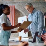 Voter signs a form at a polling station desk