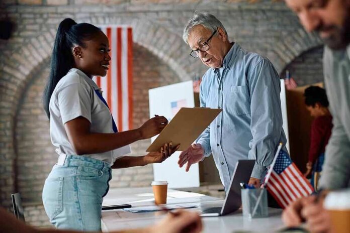 Voter signs a form at a polling station desk