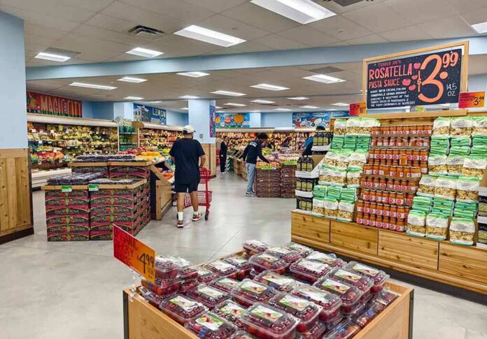 Interior of a grocery store with customers shopping for fresh produce