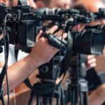 Iran’s President Holds Rare Meeting With Supreme Leader television cameras on tripods at a media event