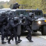 U.S. Builds New Attack Drone Force After Brutal Lessons From Iran Tactical police team advances from armored vehicle with shields and rifles