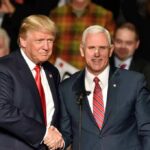 Donald Trump and Mike Pence shake hands on stage; Jeff Lord is in the background