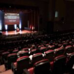 Audience in a theater watching a stage presentation