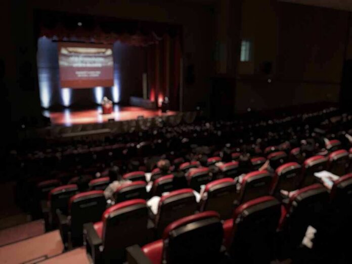 Audience in a theater watching a stage presentation