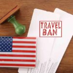 Trump State Department Revokes Record 175K Visas US passport cover with travel documents and a travel ban stamp