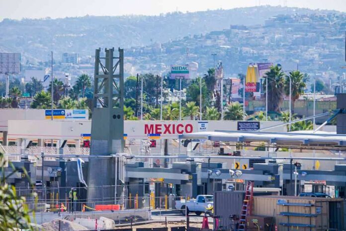 shutterstock_688819600 Border crossing booths at Mexico entry point with cityscape in background