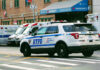 Police car and ambulances outside emergency room entrance.