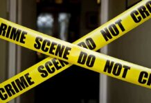 $100M Fortune Collapses Into BLOODSHED Yellow crime scene tape crossing a doorway