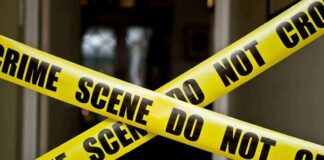 Yellow crime scene tape crossing a doorway