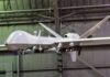 Ex-Google CEO Is Now Building ATTACK Drones military drone with missiles suspended in a hangar