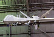 Ex-Google CEO Is Now Building ATTACK Drones military drone with missiles suspended in a hangar