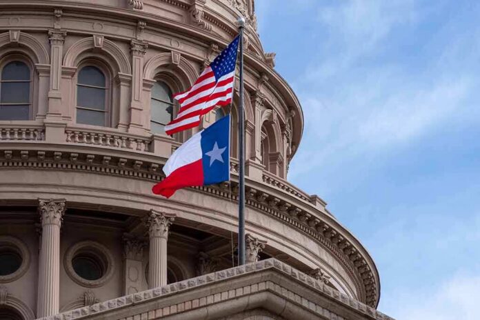 shutterstock_1216088524-1 Texas and U.S. flags in front of a capitol building dome