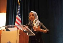 Ilhan Omar’s CITIZENSHIP Targeted by Feds Ilhan Omar speaking at a podium with a microphone